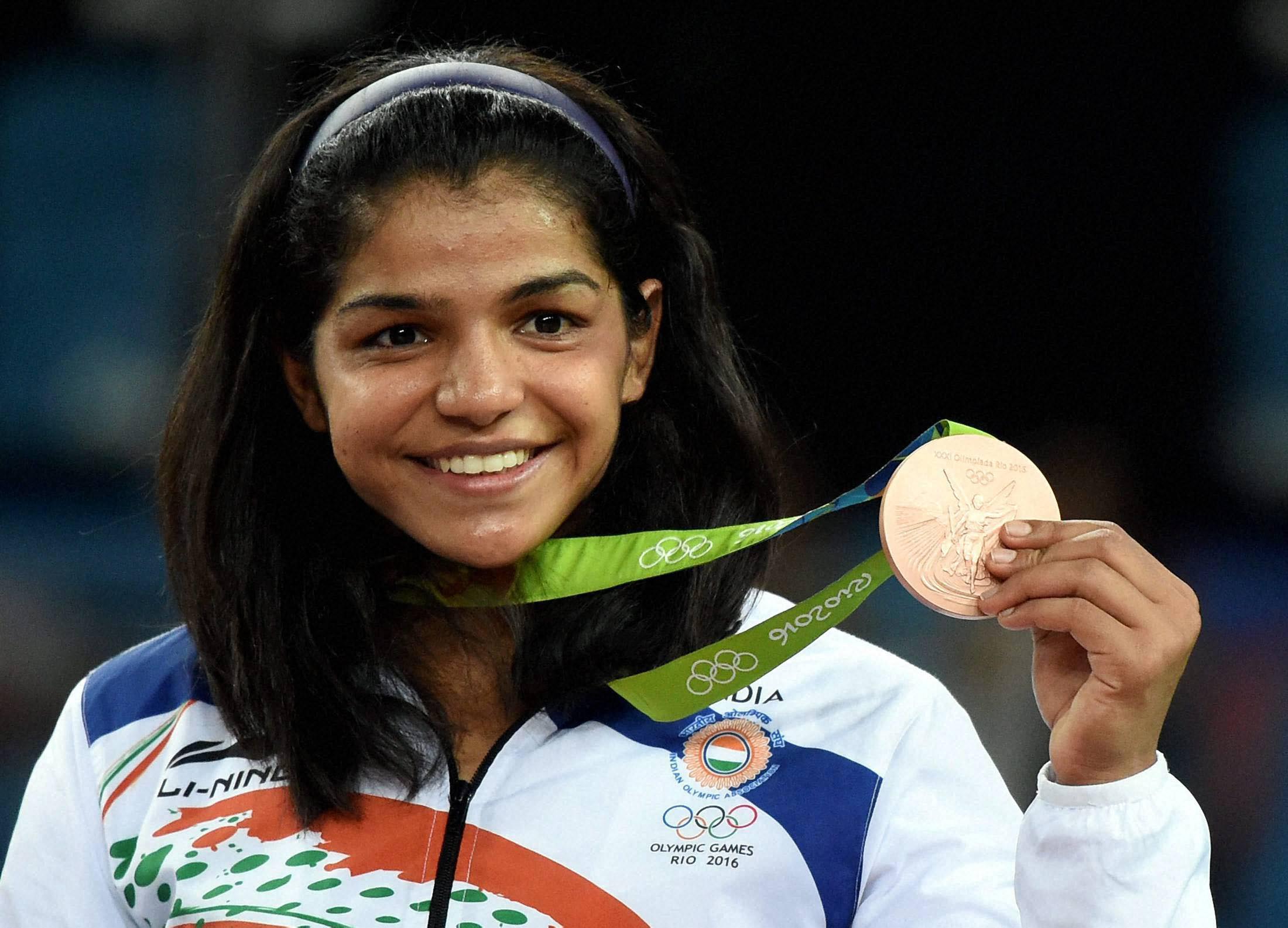 Rio de Janeiro: India's Sakshi Malik poses with her bronze medal for the women's wrestling freestyle 58-kg competition during the medals ceremony at the 2016 Summer Olympics in Rio de Janeiro, Brazil, Wednesday. PTI Photo by Atul Yadav(PTI8_18_2016_000011B)