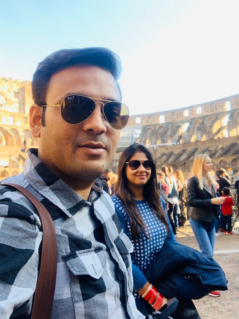 A couple inside Colosseum during their trip to Italy