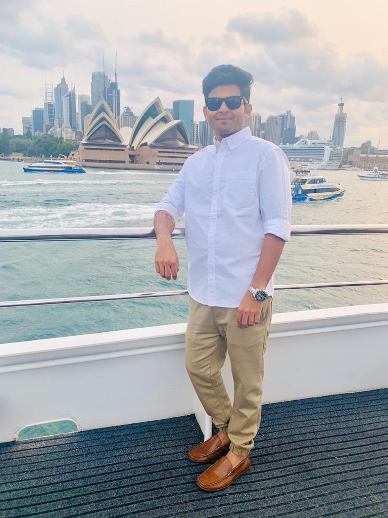 A man with the Sydney Opera house in Background