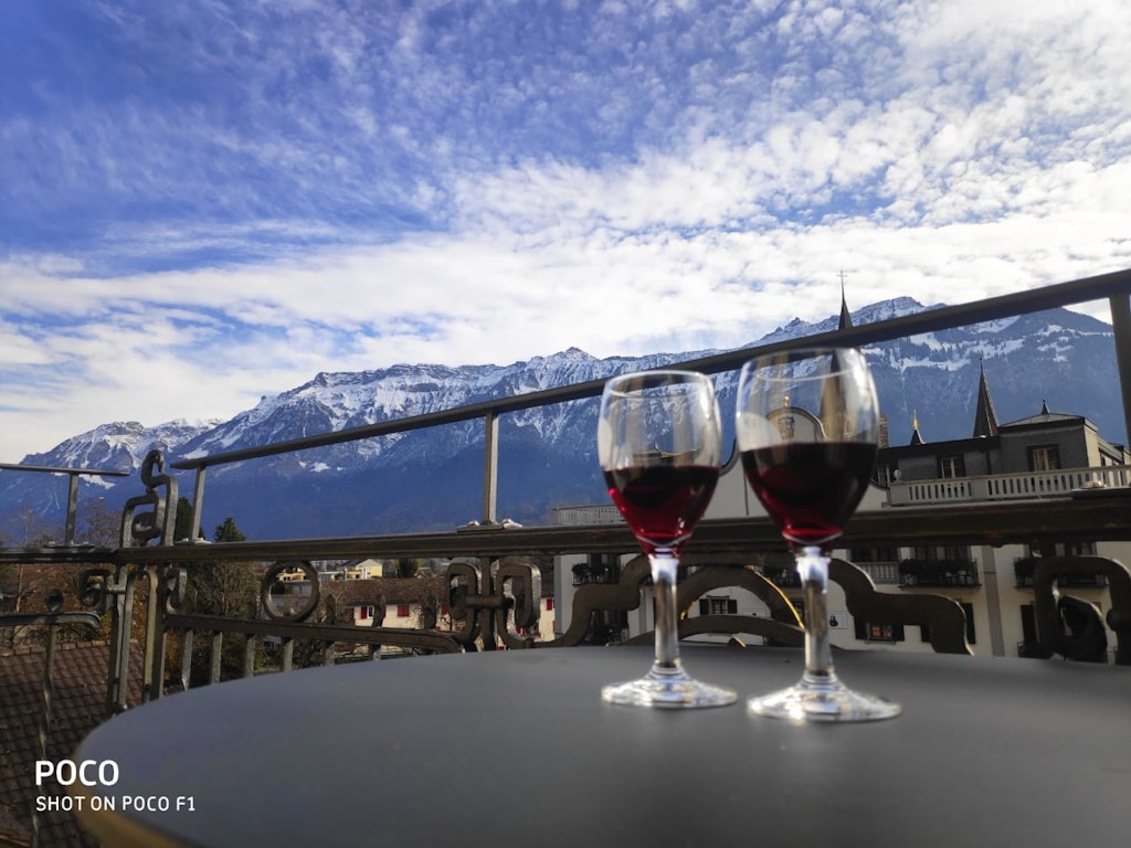 A pictures of two glasses kept on the table with beautiful skies above