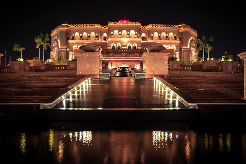 A night view of the Emirates Palace lit up with lights