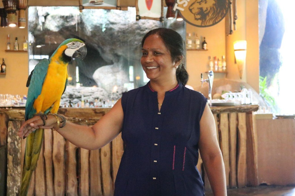 A woman with a parrot at Bali