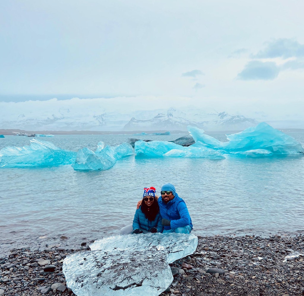 A picture of a couple sitting with ice cubes in Iceland