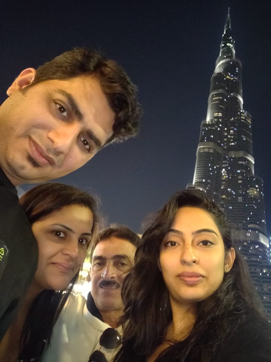 A group of people posing at the Burj Khalifa in Dubai