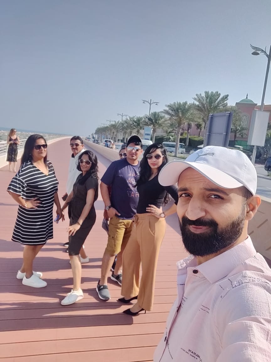 A group of people posing at the beach on their family trip to Dubai