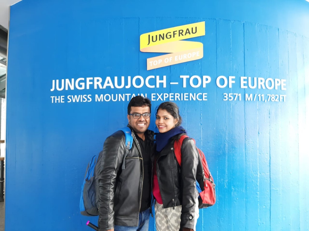 A picture of a couple posing at the Jungfraujoch on their honeymoon vacation to Europe