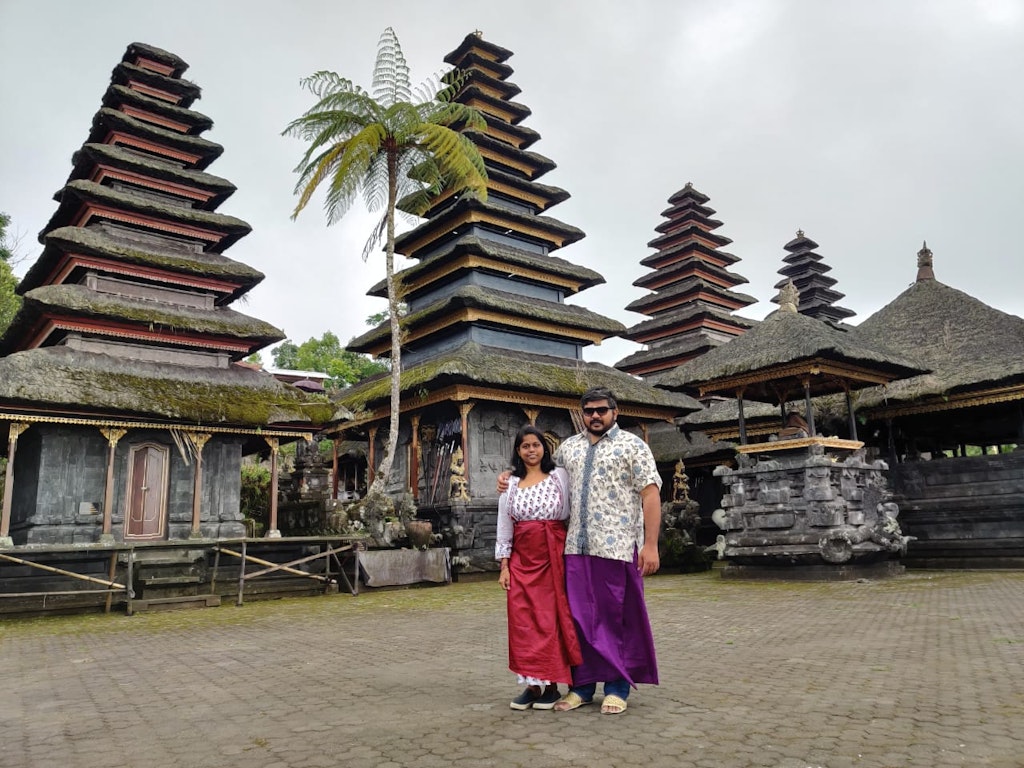 Wearing traditional attire in temple during our trip to Bali