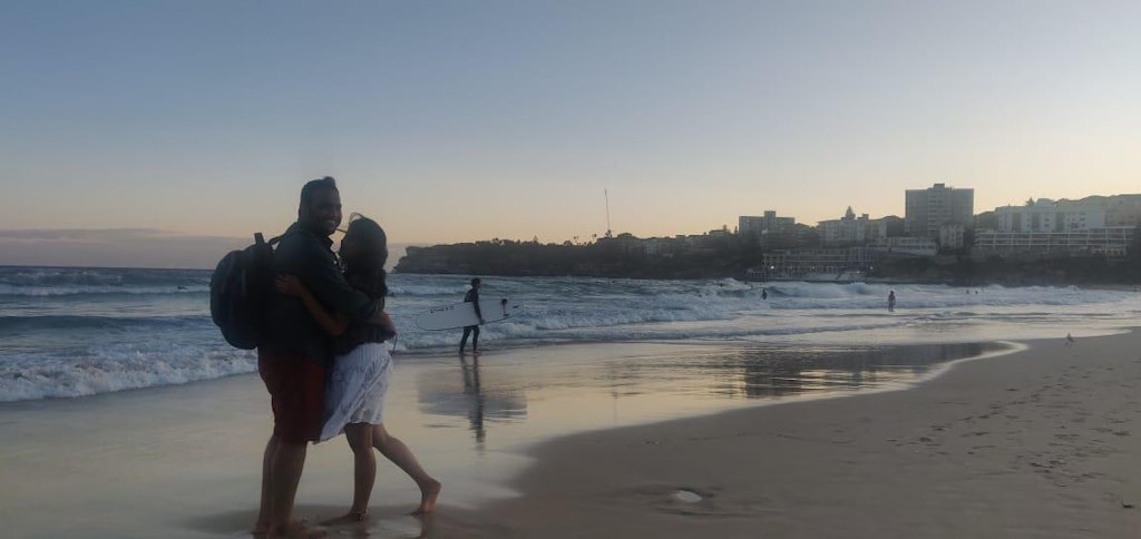 A picture of a couple posing in the beach on their honeymoon trip to Australia