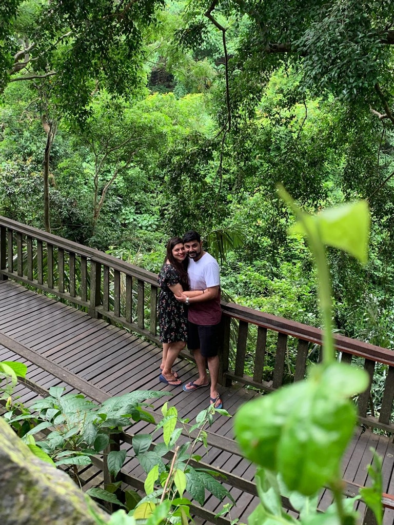 A picture of a couple surrounded by the green beauty in Bali