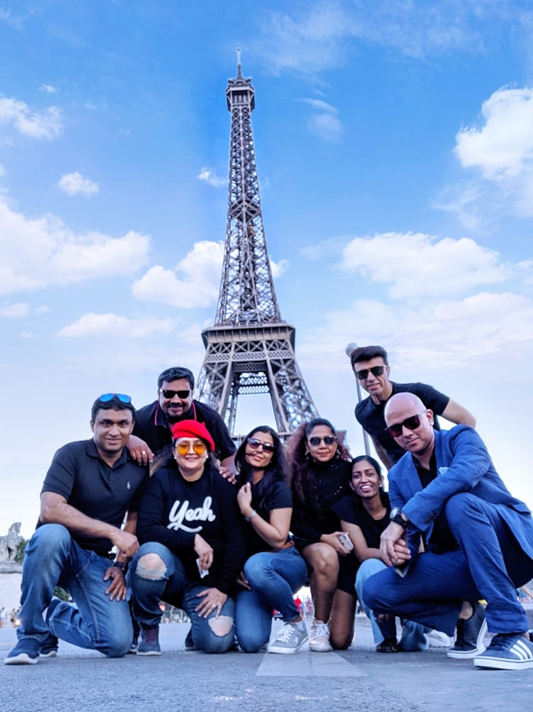 A group of friends with the shining Eiffel Tower as the background