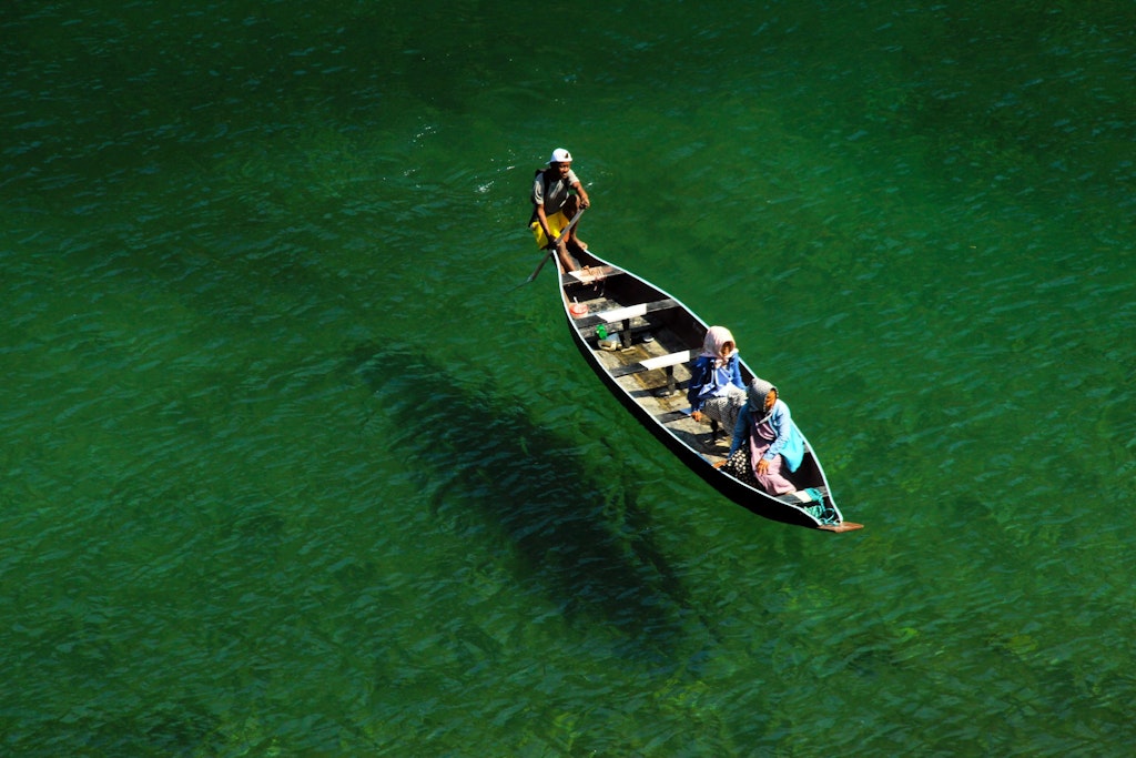 A picture of three people boating in Northeast India