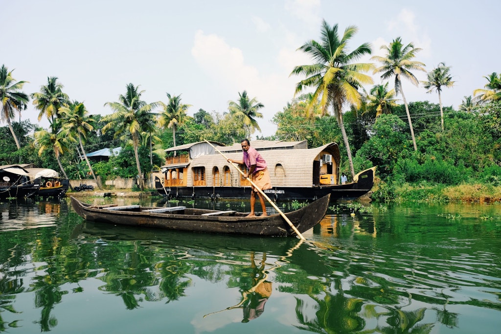 A picture of a man standing on a boat in Alleppey backwaters