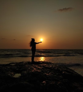 A picture of a girl enjoying sunset in Kerala