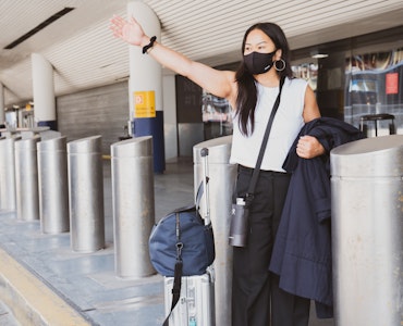 A woman wearing a mask in an airport.
