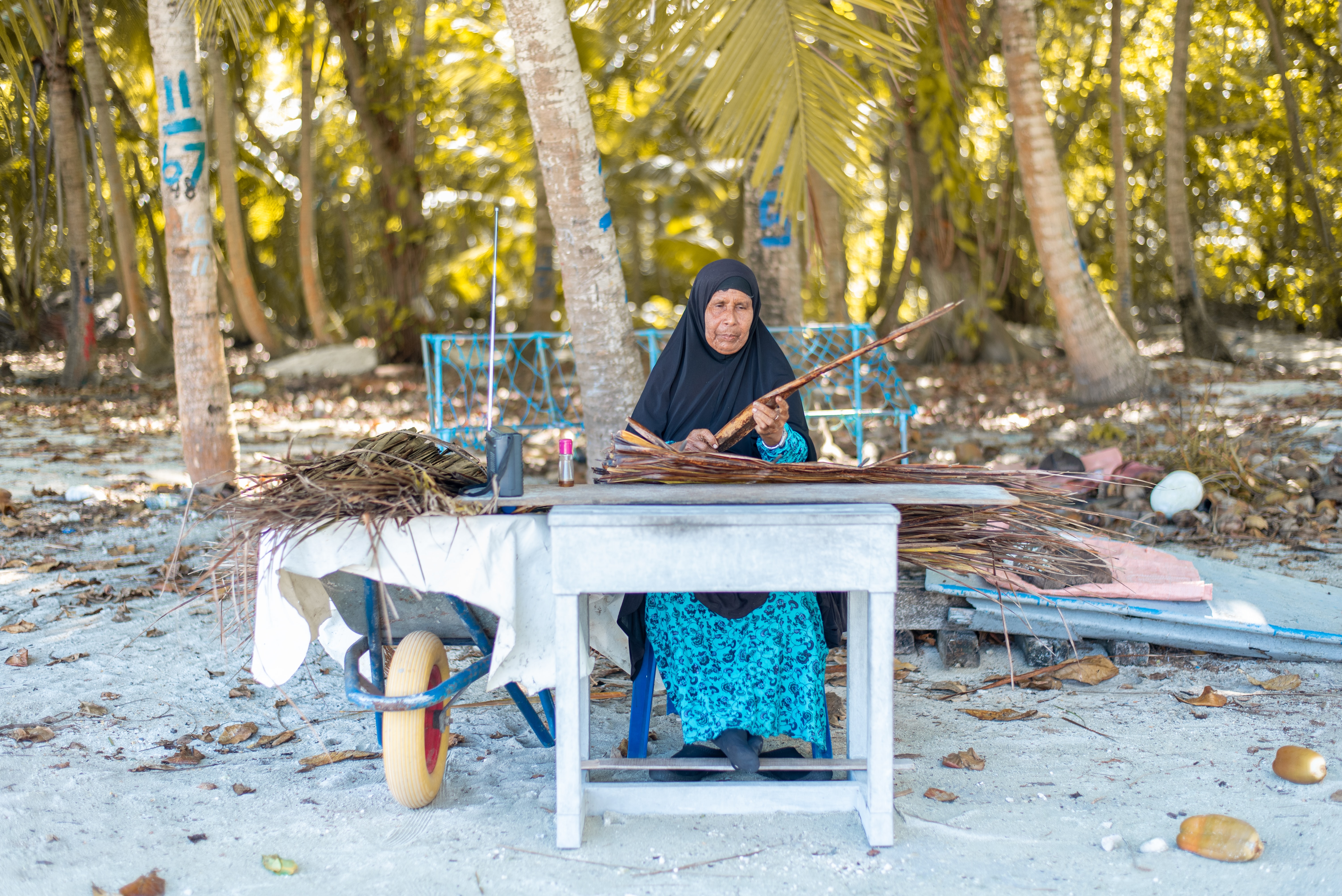 Maldives woman weaving handicrafts