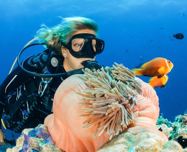 A girl exploring coral reefs in the Maldives