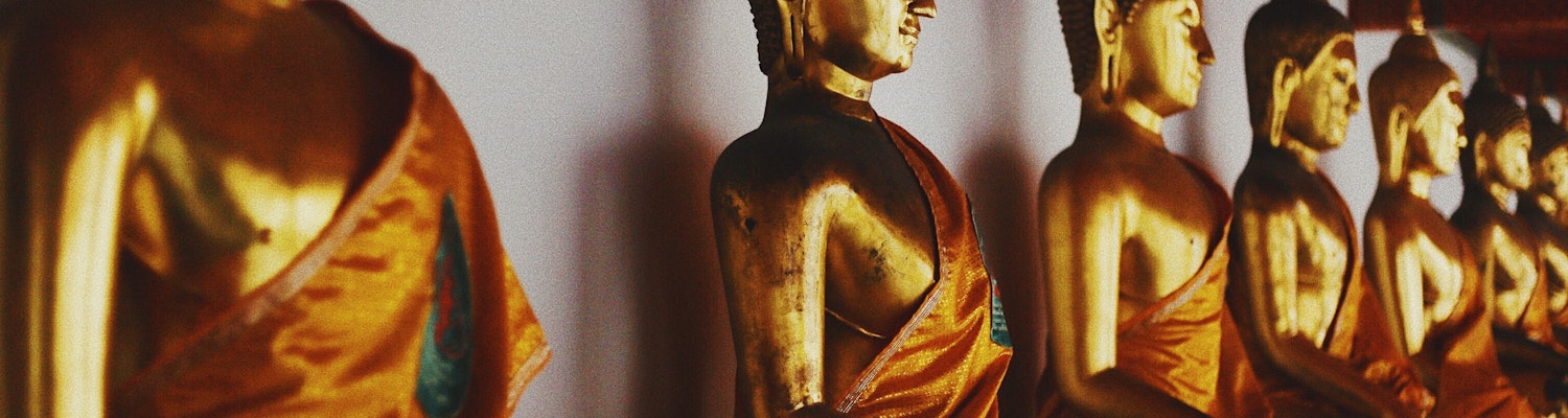 A majestic Buddha statue is shown in the picture